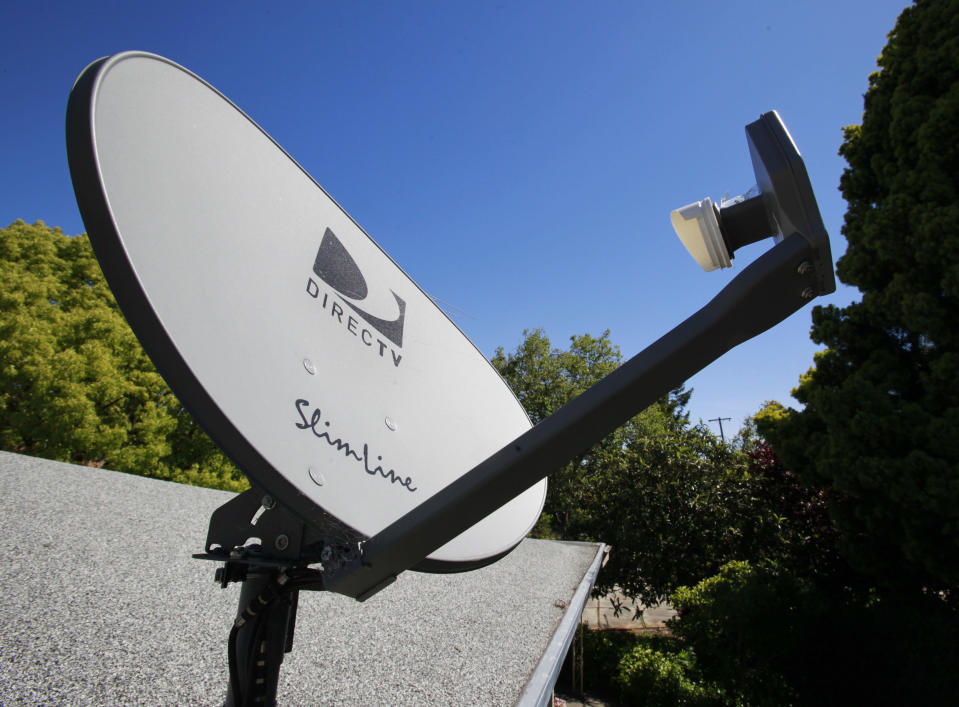 FILE - In this May 6, 2010 file photo, a DirecTV satellite dish is attached to a roof at a home in Palo Alto, Calif. The government is taking the nation's biggest satellite TV provider to court, accusing DirecTV of misleading millions of consumers about the cost of its programming. The Federal Trade Commission said Wednesday that its complaint charges DirecTV Inc. with deceptively advertising a discounted 12-month programming package. Consumers weren't clearly told that the package requires a two-year contract, the commission said. (AP Photo/Paul Sakuma, File)