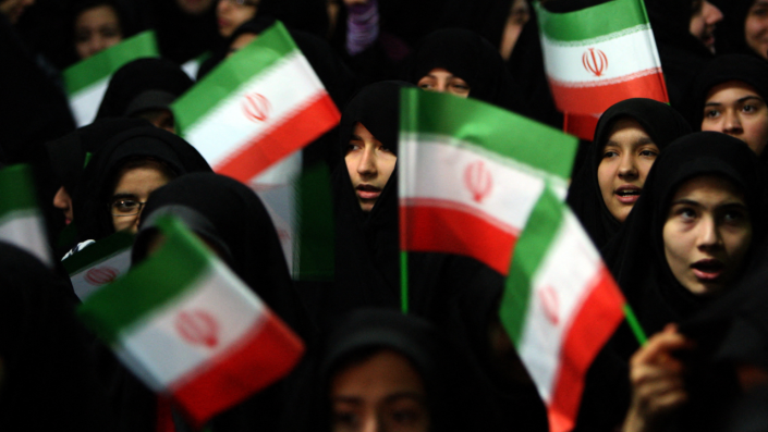 Schoolgirls wave Iranian flags during a ceremony marking the 33th anniversary of Ayatollah Ruhollah Khomeini's return from exile at Khomeini's mausoleum in Tehran on Feb. 1, 2012. <span class="copyright">Photo By Atta Kenare/AFP Via Getty Images</span>