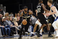 Milwaukee Bucks guard Wesley Matthews, left, drives as Indiana Pacers forward Domantas Sabonis defends during the first half of an NBA basketball game in Indianapolis, Wednesday, Feb. 12, 2020. (AP Photo/AJ Mast)