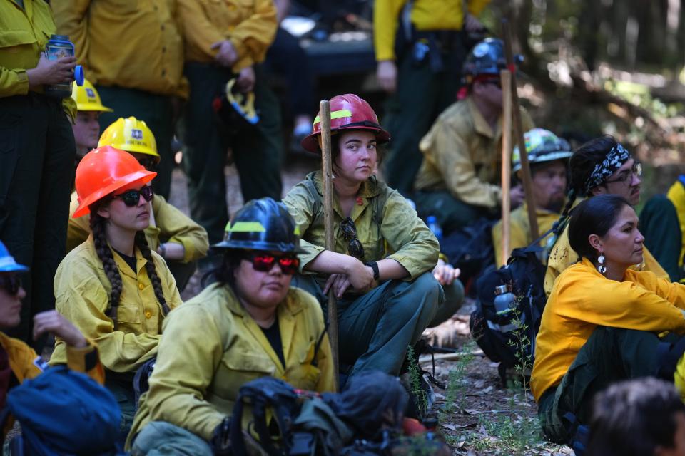 Volunteers plan a controlled burn around Karuk ancestral territory, which includes land owned by the U.S. Forest Service and private landowners. on Monday, Oct. 3, 2022, as part of a Indigenous Women-In-Fire Training Exchange program.