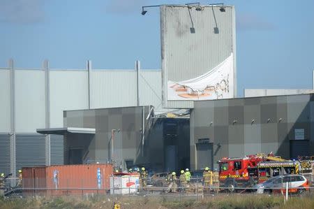 Fire crew at the scene where a light plane crashed into the back of a building at Essendon airport in Melbourne, Australia, February 21, 2017. AAP/Joe Castro/via REUTERS