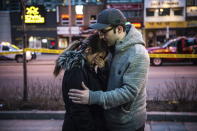 <p>Farzad Salehi consoles his wife, Mehrsa Marjani, who was at a nearby cafe and witnessed the aftermath when a van plowed down a crowded sidewalk, killing multiple people and injuring others, Monday, April 23, 2018, in Toronto. (Photo: Aaron Vincent Elkaim/The Canadian Press via AP) </p>