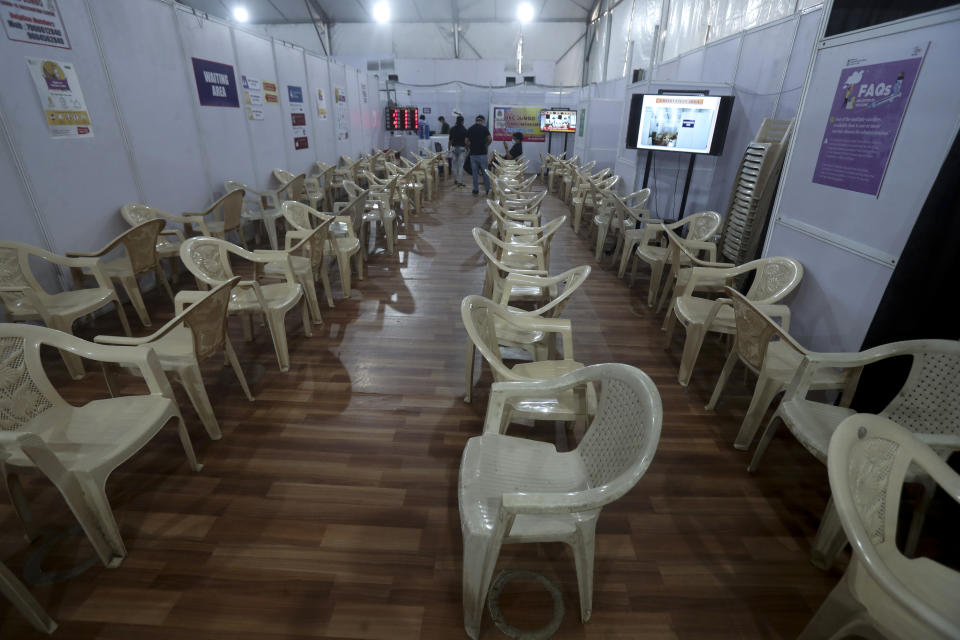 FILE - In this May. 3, 2021, file photo, health workers sit in the waiting area of vaccination center which has been closed because of shortage of the COVID-19 vaccine in Mumbai, India. COVID-19 infections and deaths are mounting with alarming speed in India with no end in sight to the crisis. People are dying because of shortages of bottled oxygen and hospital beds or because they couldn’t get a COVID-19 test. (AP Photo/Rafiq Maqbool, File)