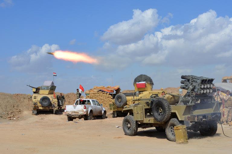 Iraqi forces and allied militias fire rockets from a position in the northern part of Diyala province as they take part in an assault to retake the city of Tikrit from jihadists of the Islamic State (IS) group on March 2, 2015