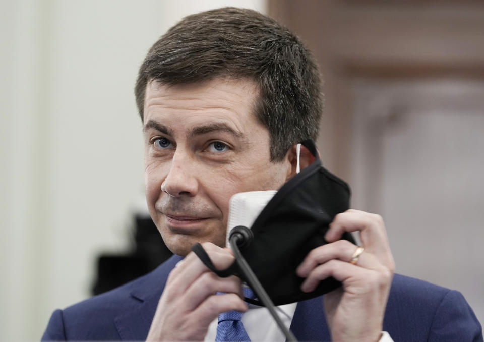 Transportation Secretary nominee Pete Buttigieg removes his face mask to speak during a Senate Commerce, Science and Transportation Committee confirmation hearing on Capitol Hill, Thursday, Jan. 21, 2021, in Washington. (Ken Cedeno/Pool via AP)