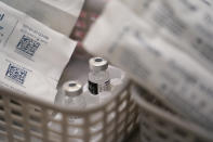 Vials of the Pfizer COVID-19 vaccine ready to be administered, at Swaminarayan School vaccination centre, in London, Saturday, Dec. 4, 2021. Britain says it will offer all adults a booster dose of vaccine within two months to bolster the nation's immunity as the new omicron variant of the coronavirus spreads. New measures to combat variant came into force in England on Tuesday, with face coverings again compulsory in shops and on public transport. (AP Photo/Alberto Pezzali)