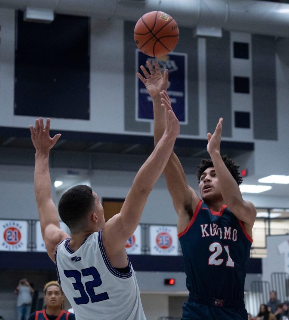 Kokomo Wildkats forward Karson Rogers (21) shoots the ball over Ben Davis Giants Shaun Arnold (32) during the Sneakers for Santa Shootout Saturday, Dec. 3, 2022, at Brownsburg High School.