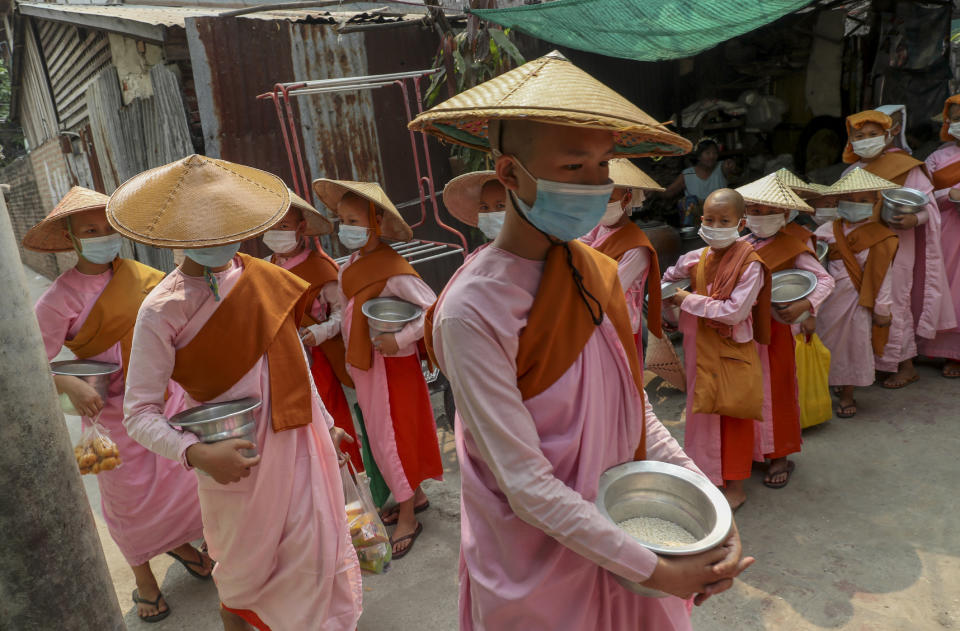 Buddhist nuns collect alms in Mandalay, Myanmar, Thursday, March 11, 2021. The U.N. Security Council unanimously called for a reversal of the military coup in Myanmar on Wednesday, strongly condemning the violence against peaceful protesters and calling for “utmost restraint” by the military. (AP Photo)