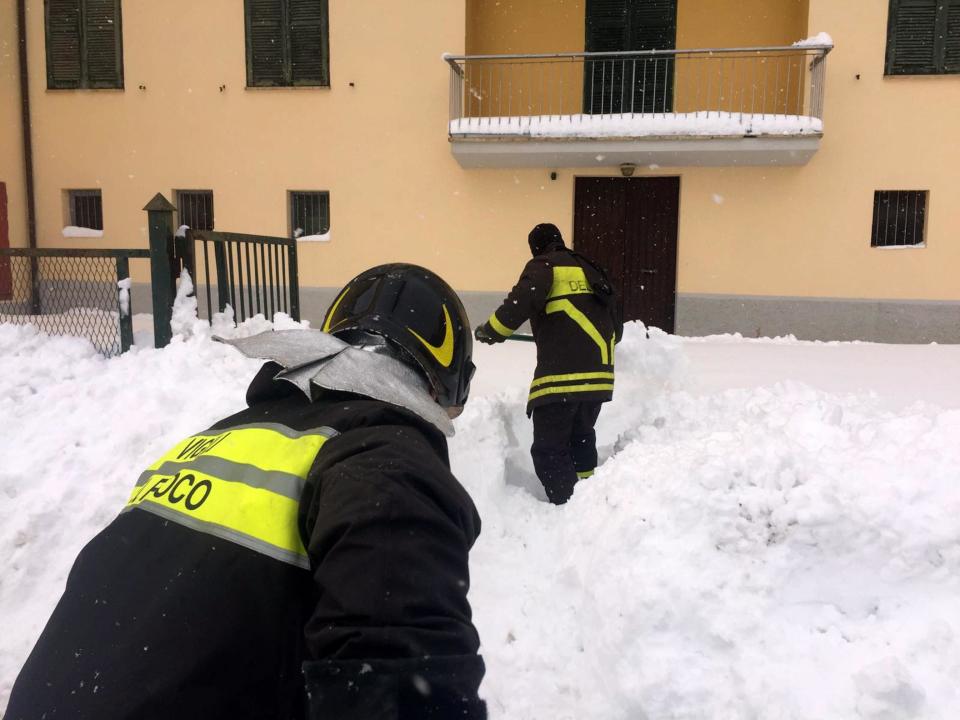 Firefighters shovel snow in Montereale, central Italy, Wednesday, Jan. 18, 2017. Montereale was the epicenter of three strong earthquakes that shook central Italy in the space of an hour Wednesday, striking the same region that suffered a series of deadly quakes last year and further isolating towns that have been buried under more than a meter (three feet) of snow for days. (Claudio Lattanzio/ANSA via AP)