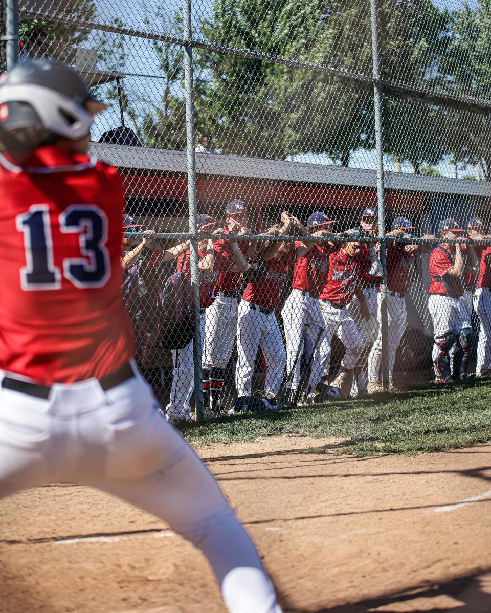 The Firebirds benchwatches as Reese Acord (13) prepares to launch a home run over the left field fence during a PIAA 4A State Playoff game between Littlestown and Holy Ghost Prep. June 6, 2022. Holy Ghost won 9-0.