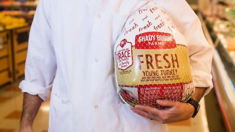 person holding fresh turkey