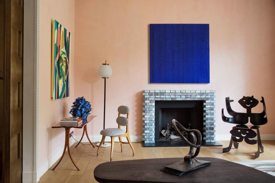 In the living room, a glass-bead artwork by Liza Lou hangs above a Benoit mantelpiece. Zebrawood console by David Ebner, 1950s Italian chair, vintage Stilnovo floor lamp, Roberto Matta armchair.