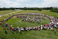 <p>Protesters encircle a group standing to form letters that spell “Impeach Trump,” during a rally to protest President Donald Trump and his policies, on the National Mall, Saturday, June 3, 2017, in Washington. (Photo: Alex Brandon/AP) </p>