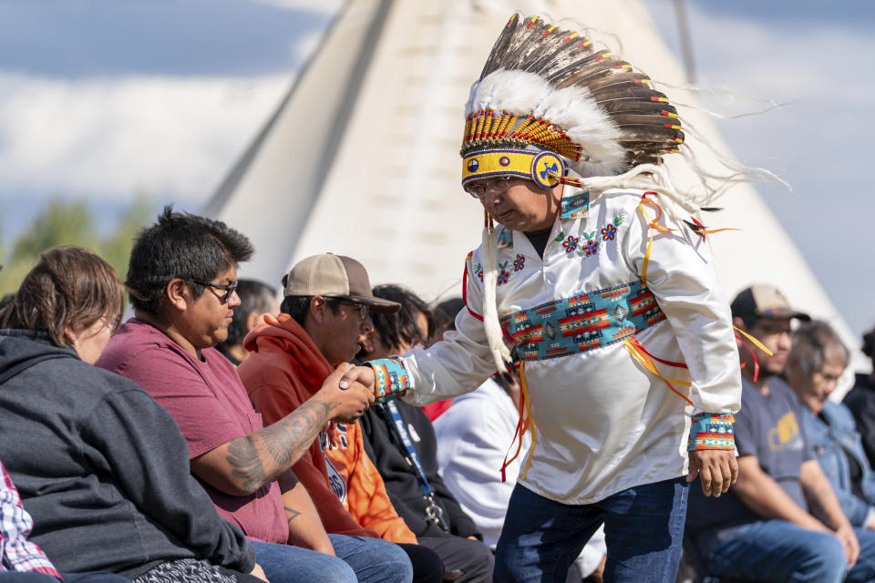 James Smith Cree Nation Chief Wally Burns greets a victim's family member during a Federation of Sovereign Indigenous Nations event where leaders provide statements about the mass stabbing incident that happened at James Smith Cree Nation and Weldon, Saskatchewan, Canada, at James Smith Cree Nation, Saskatchewan, Canada, on Thursday, Sept. 8, 2022. (Heywood Yu/The Canadian Press via AP)