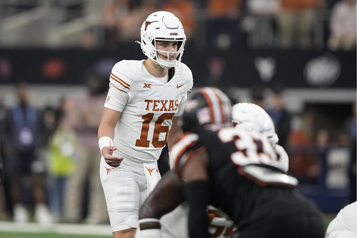 Texas quarterback Arch Manning (16) stands at the line of scrimmage during the Big 12 Conference championship NCAA college football game against Oklahoma State in Arlington, Texas, Saturday, Dec. 2, 2023. (AP Photo/Tony Gutierrez)