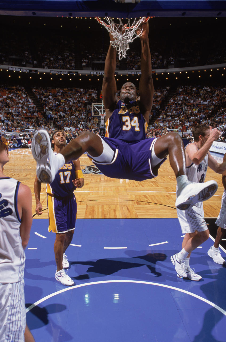 Shaquille O'Neal hangs from the basket during the NBA game against the Orlando Magic at the TD Waterhouse in Orlando, Florida on January 30, 2002. (Andy Lyons/Getty Images)