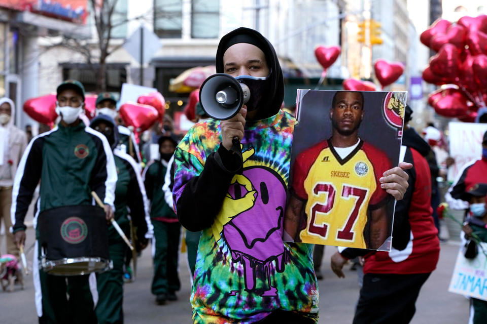 People march through the streets with balloons and placards towards Washington Square in memory of Jamarion Robinson who was shot 76 times by federal agents on April 3, 2021 in New York City. (John Lamparski / NurPhoto via AP)