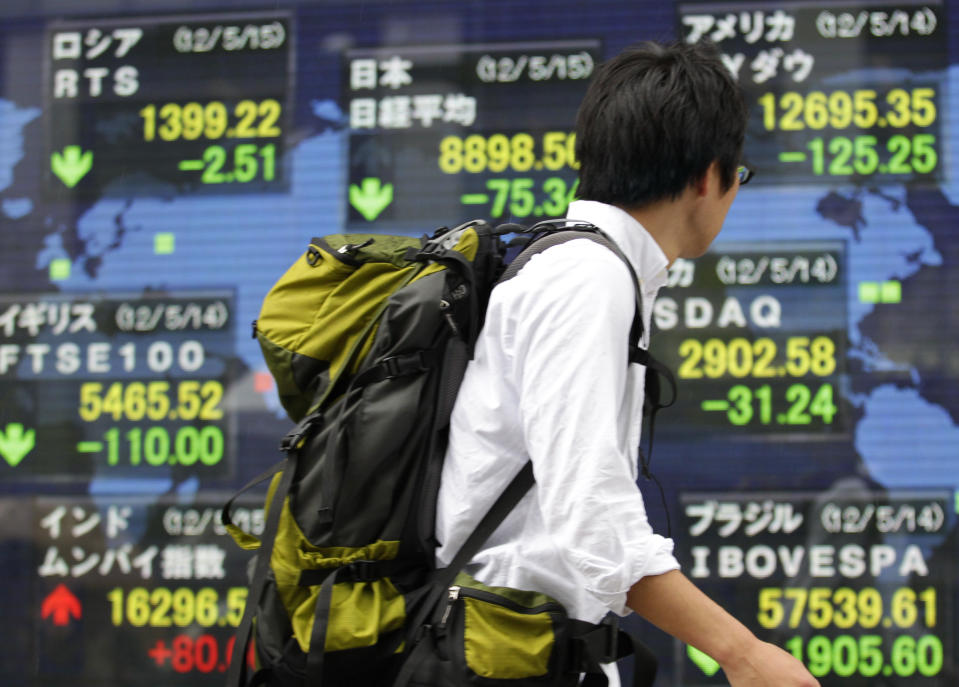 A man looks at an electronic stock indicator in Tokyo Tuesday, May 15, 2012. Asian stock markets were mostly lower Tuesday, rattled by a political impasse in Greece that could lead the debt-stricken country to a destabilizing exit from the euro currency union. Japan's Nikkei 225 index fell 73.10 points, or 0.81 percent, to close at 8,900.74, a new three-month low. (AP Photo/Shizuo Kambayashi)