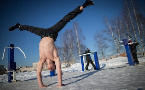 Dmitri Nalivaiko, 17, performs a handstand at the Novgorod street workout court - Credit: Dmitri Beliakov/For The Telegraph