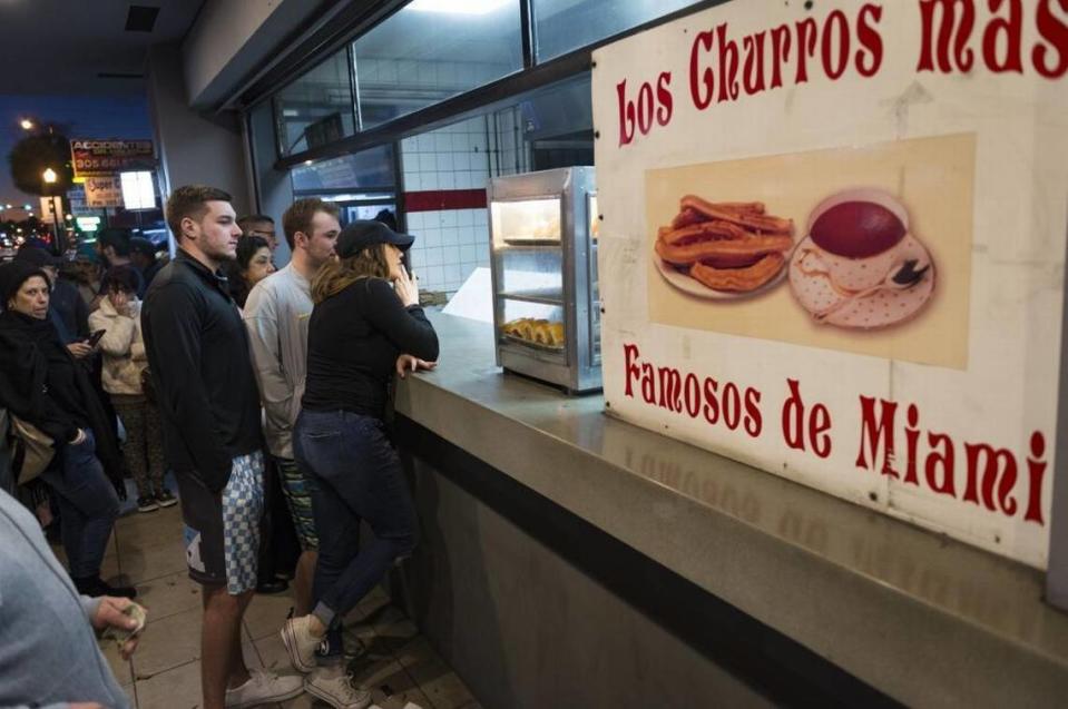 Los clientes haciendo fila para comer churros y chocolate en una fría noche de Miami en La Palma, en la Calle Ocho.