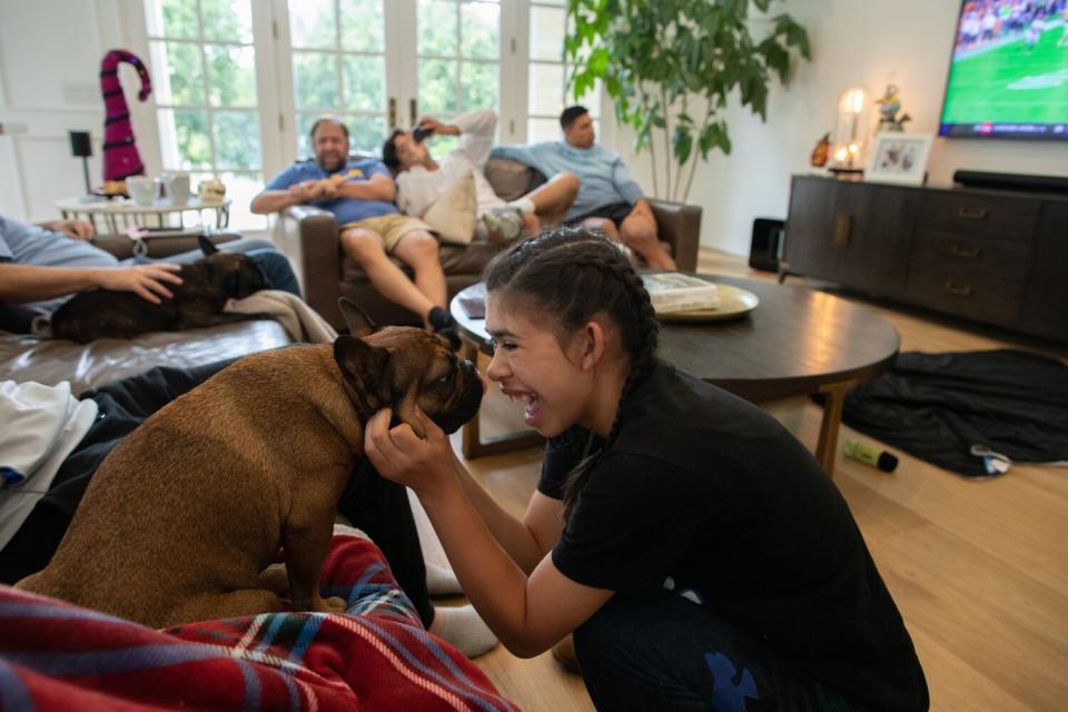 Bella Hall nuzzles Bebe during a Saturday family gathering.