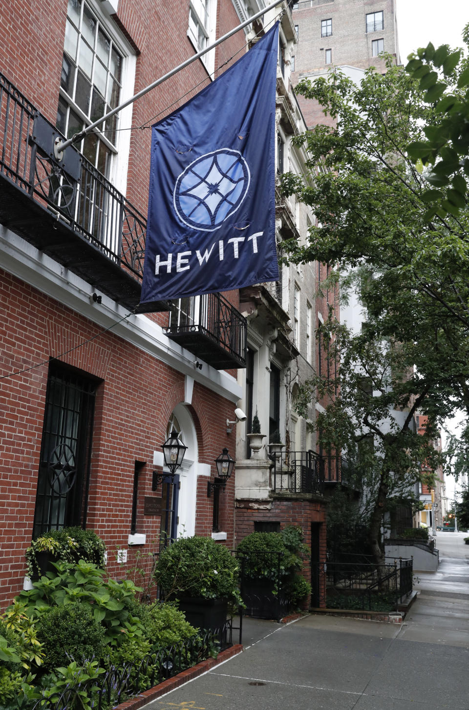 This July 11, 2019, photo, shows the Hewitt School, an all-girls' school located blocks from Financier Jeffrey Epstein's Upper East Side mansion in New York. In the decade since striking a plea deal that required Epstein to register as a child sex offender, he has sought to underwrite all manner of youth causes, such as a baseball program and the school. Some donations, including $15,000 to the school, were returned once recipients learned where they came from. (AP Photo/Kathy Willens)
