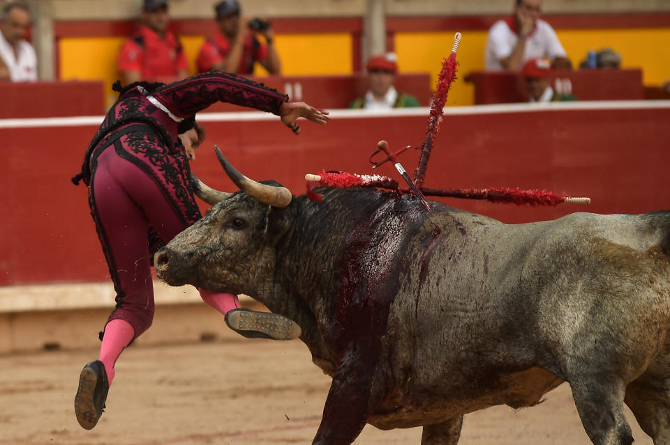 <p>Spanish bullfighter Javier Castano is gored by a Jose Escolar’s bull in the bullring at the San Fermin Festival in Pamplona, northern Spain, July 8, 2018. (Photo: Alvaro Barrientos/AP) </p>
