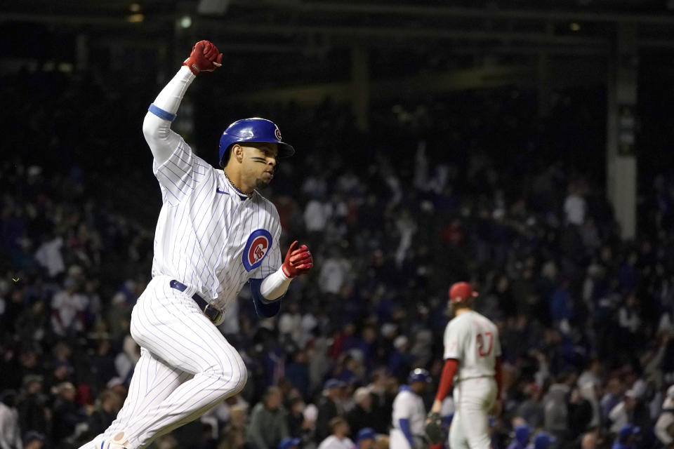 Chicago Cubs' Christopher Morel rounds first and celebrates his three-run home run off Philadelphia Phillies starting pitcher Aaron Nola, right, during the fifth inning of a baseball game Wednesday, Sept. 28, 2022, in Chicago. (AP Photo/Charles Rex Arbogast)