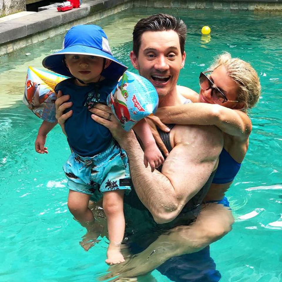 Tiffiny Hall in a swimming pool with her husband, Ed Kavalee, and their son, Arnold. Photo: Instagram/tiffhall_xo.