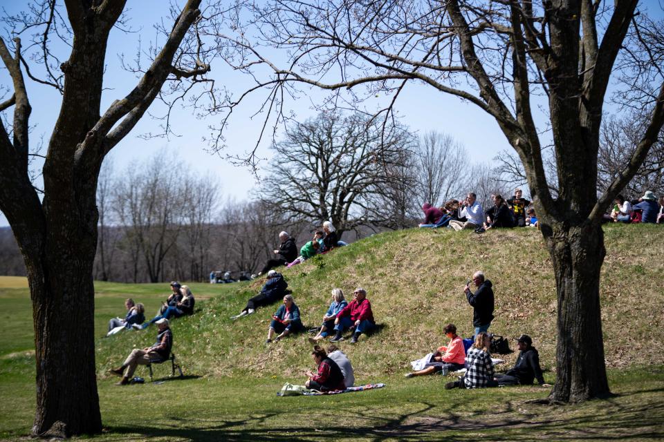 Iowans look to the sky through their solar eclipse glasses as the eclipse reaches its peak Monday, April 8, 2024, at the Drake Municipal Observatory.