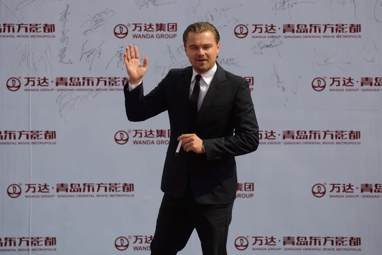 Actor Leonardo DiCaprio waves during a red carpet event showcasing plans for the ambitious Oriental Movie Metropolis in Qingdao on September 22, 2013