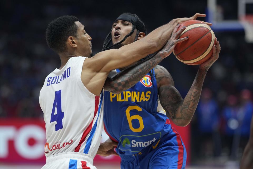 Philippines guard Jordan Clarkson (6) is blocked by Dominican Republic guard Gelvis Solano (4) during their match at the Basketball World Cup at the Philippine Arena in Bulacan province, Philippines Friday, Aug. 25, 2023. (AP Photo/Aaron Favila)