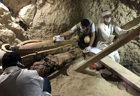 Egyptian antiquities workers are seen in a recently discovered tomb of Userhat, a judge from the New Kingdom at the Dra Abu-el Naga necropolis near the Nile city of Luxor, south of Cairo, Egypt April 18, 2017. REUTERS/ Mohamed Zaki