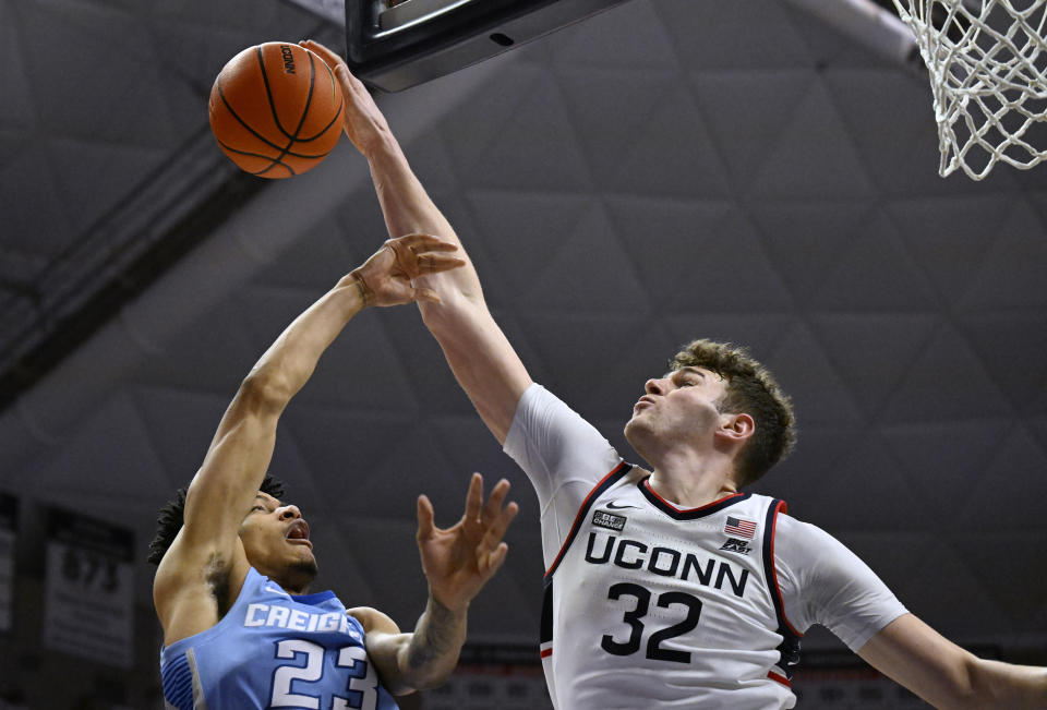 UConn center Donovan Clingan (32) blocks a shot by Creighton guard Trey Alexander (23) in the first half of an NCAA college basketball game, Wednesday, Jan. 17, 2024, in Stores, Conn. (AP Photo/Jessica Hill)