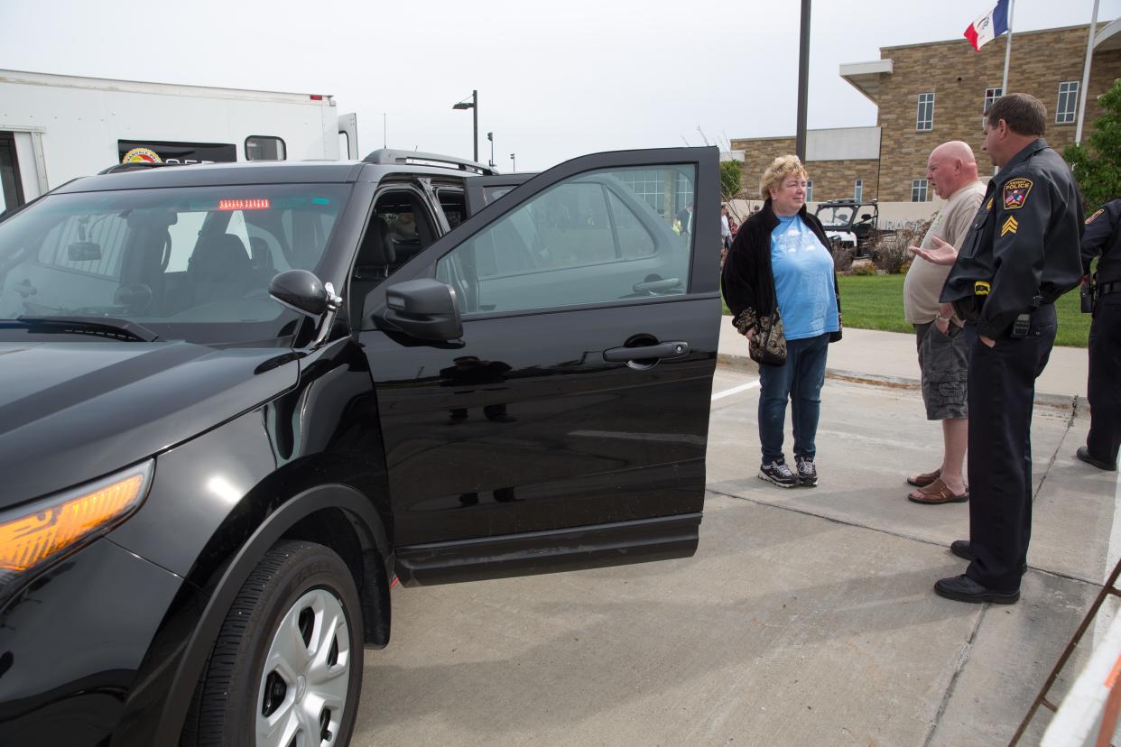Sgt. Scott Crouch talks about an unmarked police SUV with Gayanne Smith and David Appelhans of Ankeny Tuesday, May 19, 2015, during the Ankeny Police Department’s Free Community Picnic at the police headquarters in Ankeny.