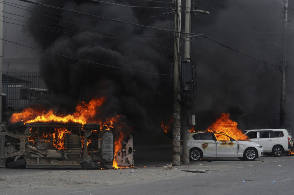 Vehicles set on fire by protesters in Mombasa, Kenya Tuesday, July 2, 2024. Protests have continued to rock several towns in Kenya including the capital Nairobi, despite the president saying he will not sign a controversial finance bill that sparked deadly protests last week. (AP Photo/Gideon Maundu)