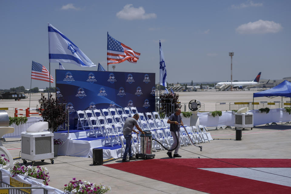 Workers clean the red carpet ahead of the arrival of U.S. President Joe Biden at Ben Gurion airport near Tel Aviv, Israel, Wednesday, July 13, 2022. (AP Photo/Ariel Schalit)