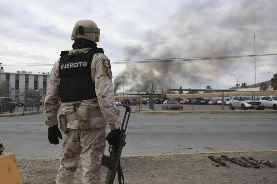 A Mexican soldiers stands guard outside a state prison in Ciudad Juarez, Mexico, Sunday Jan 1, 2023. Mexican soldiers and state police regained control of a state prison in Ciudad Juarez across the border from El Paso, Texas after violence broke out early Sunday, according to state officials. (AP Photo/Christian Chavez)