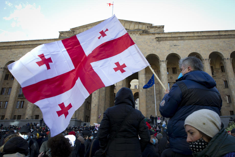 Georgian opposition supporters attend a rally following the detention of the United National Movement party leader Nika Melia, Tbilisi, Georgia, Tuesday, Feb. 23, 2021. Protesters denouncing the arrest of the head of Georgia's main opposition party have set up tents outside the country's parliament building and blocked the capital's main avenue. Tensions in Georgia have been strong since the October parliamentary election that the opposition is demanding be rerun. (AP Photo/Shakh Aivazov)