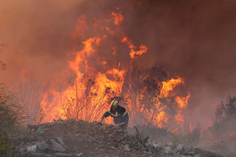 A volunteer works during a wildfire at the 'Santa Rosa de Colmo' area, in Valparaiso