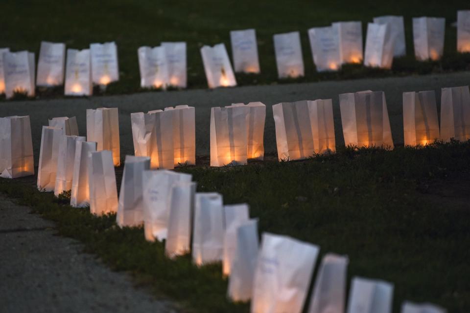 Luminarias light up the sidewalk on Thursday, Oct. 10, 2019, outside the East Lansing Library. Michigan State University Parents of Sister Survivors (POSSE) and The Army of Sister Survivors lit more than 505 luminarias as a reminder of the effects of sexual abuse prior to President Samuel Stanley's meeting with Larry Nassar survivors inside the library.