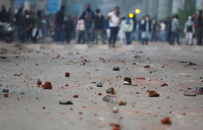 Stones are seen on the road during a protest against the Citizenship Amendment Bill in New Delhi