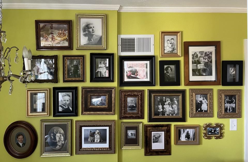 Mix and match frames in black and gold add interest to a collection of family photos.