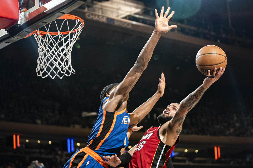 Miami Heat forward Caleb Martin (16) attempts a shot over New York Knicks forward Precious Achiuwa (5) during the first half of an NBA basketball game on Saturday, Jan. 27, 2024, in New York. (AP Photo/Peter K. Afriyie)