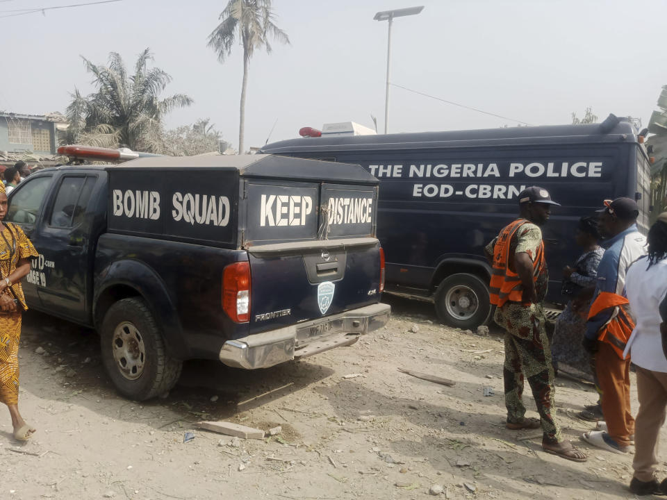 Police cars and residents gather at the site of an explosion in Ibadan, Nigeria, Wednesday , Jan. 17, 2024. Several people died and many others were injured after a massive blast caused by explosives rocked more than 20 buildings in one of Nigeria's largest cities Tuesday night, authorities said Wednesday, as rescue workers dug through the rubble in search of those feared trapped. (AP Photo)
