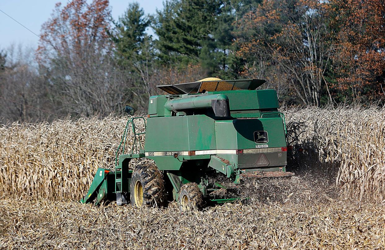A farmer harvests his field of corn on Township Road 1153 in Ashland on Friday, Nov. 12, 2021.