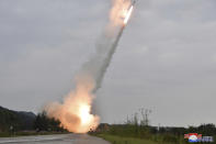 This undated photo provided on Friday, Sept. 13, 2024, by the North Korean government shows what they say is test-firing from their new launch vehicle of 600mm multiple rockets at an undisclosed location in North Korea. Independent journalists were not given access to cover the event depicted in this image distributed by the North Korean government. The content of this image is as provided and cannot be independently verified. Korean language watermark on image as provided by source reads: "KCNA" which is the abbreviation for Korean Central News Agency. (Korean Central News Agency/Korea News Service via AP)