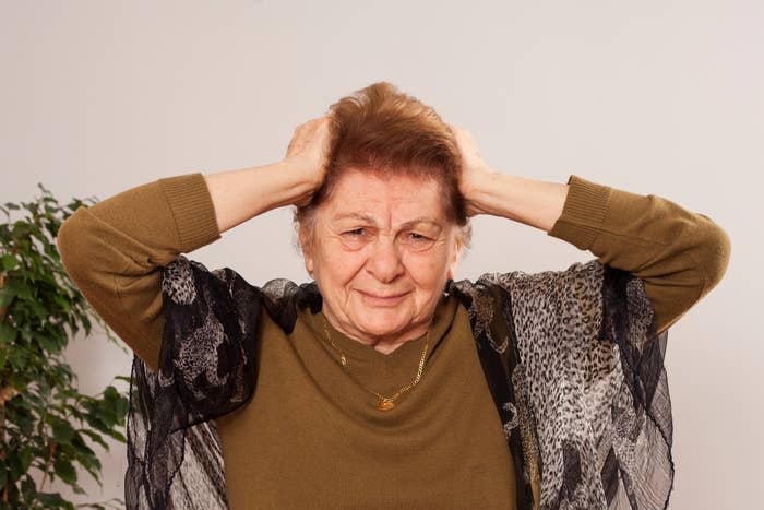 A woman with her hands on her head in exasperation