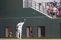 Texas Rangers right fielder Joey Gallo tosses a ball to a fan after catching it in the fifth inning of a baseball game against the Seattle Mariners, Saturday, May 8, 2021, in Arlington, Texas. (AP Photo/Louis DeLuca)