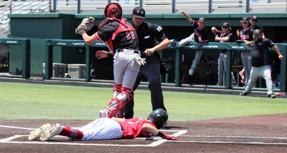 New Home players celebrate as the umpire calls out Stryker Dillard, who tried to score on a flyball to right field. Leopards outfielder Brady Brown threw home to catcher Ryan Bundy for the out to end the third inning and keep New Home's 1-0 lead.